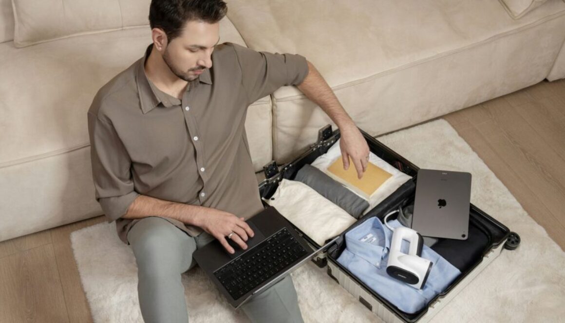 thumbnail-5 A man sitting on a couch using a laptop computer