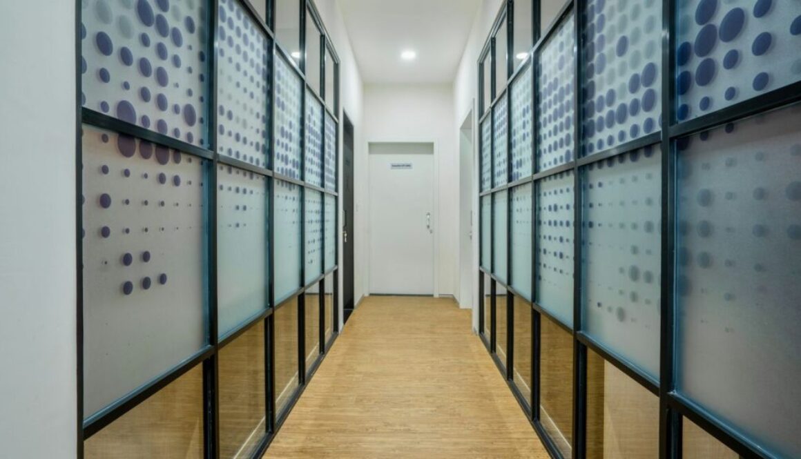 thumbnail-6 a long hallway with glass walls and a wooden floor